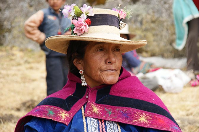 A Chola (local woman) with a flower-strewn hat, at her grandson's school picnic, Hatun Machay, Cordillera Negra 2008