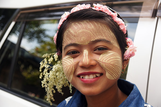 A local girl wearing traditional Thanaka wood (Hesperethusa crenulata) paste on her face as sunscreen, Innwa 2015