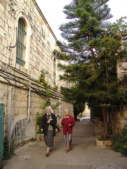 Sisters from The Monastery of Les Soeurs de Notre-Dame de Sion rush to the morning Mass through the alleys of Ein Kerem, 2008