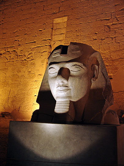 A statue of Ramesses II in front of the entrance Pylon to the Luxor Temple of Thebes, illuminated at night, 2006