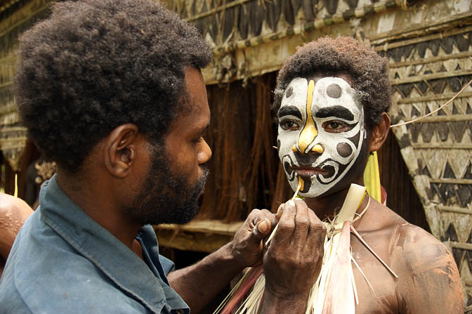 Applying makeup for a singsing (cultural show) in Yamok, the Sepik River 2009